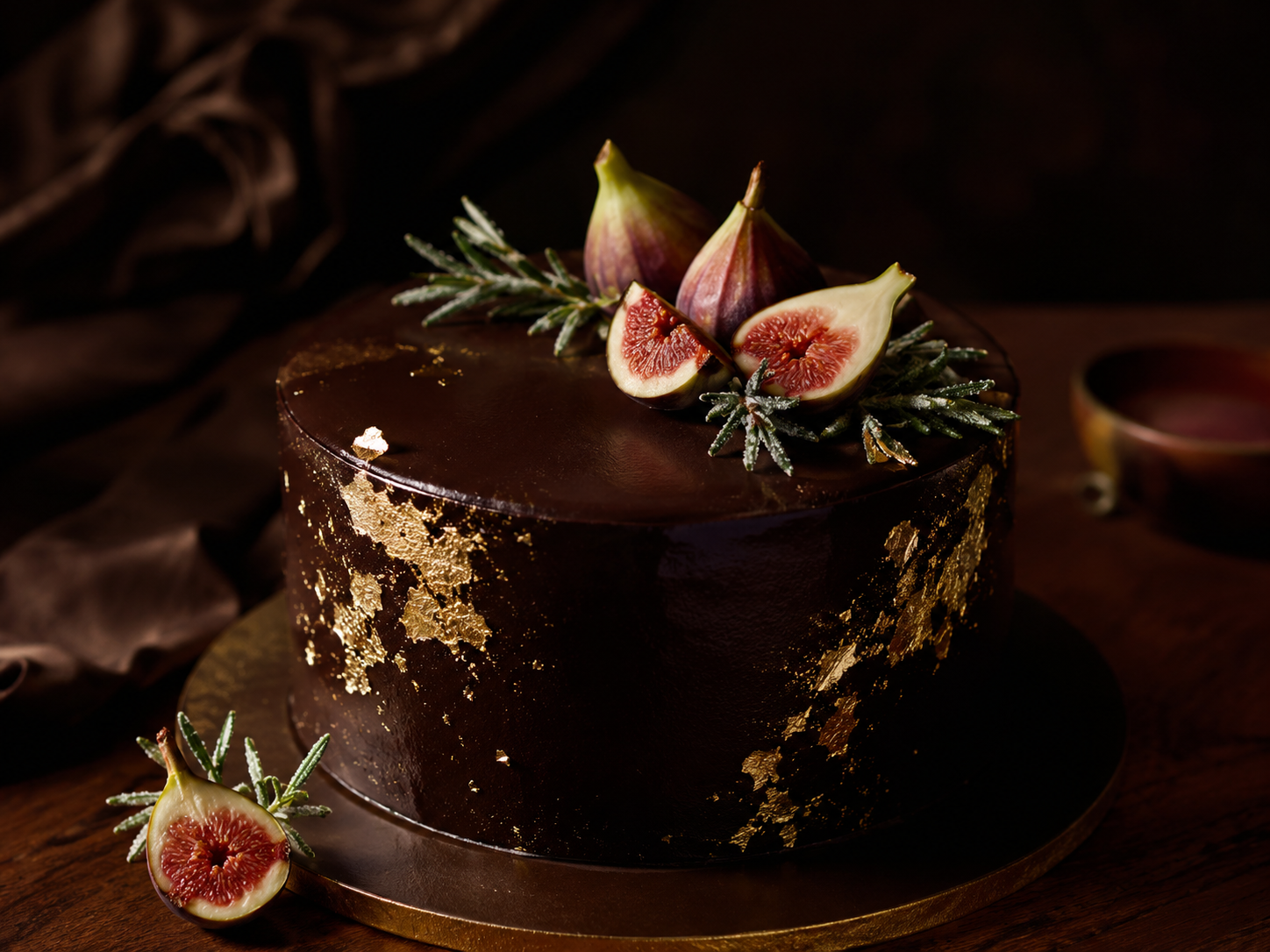 Signature dark chocolate cake with gold leaf and fresh figs